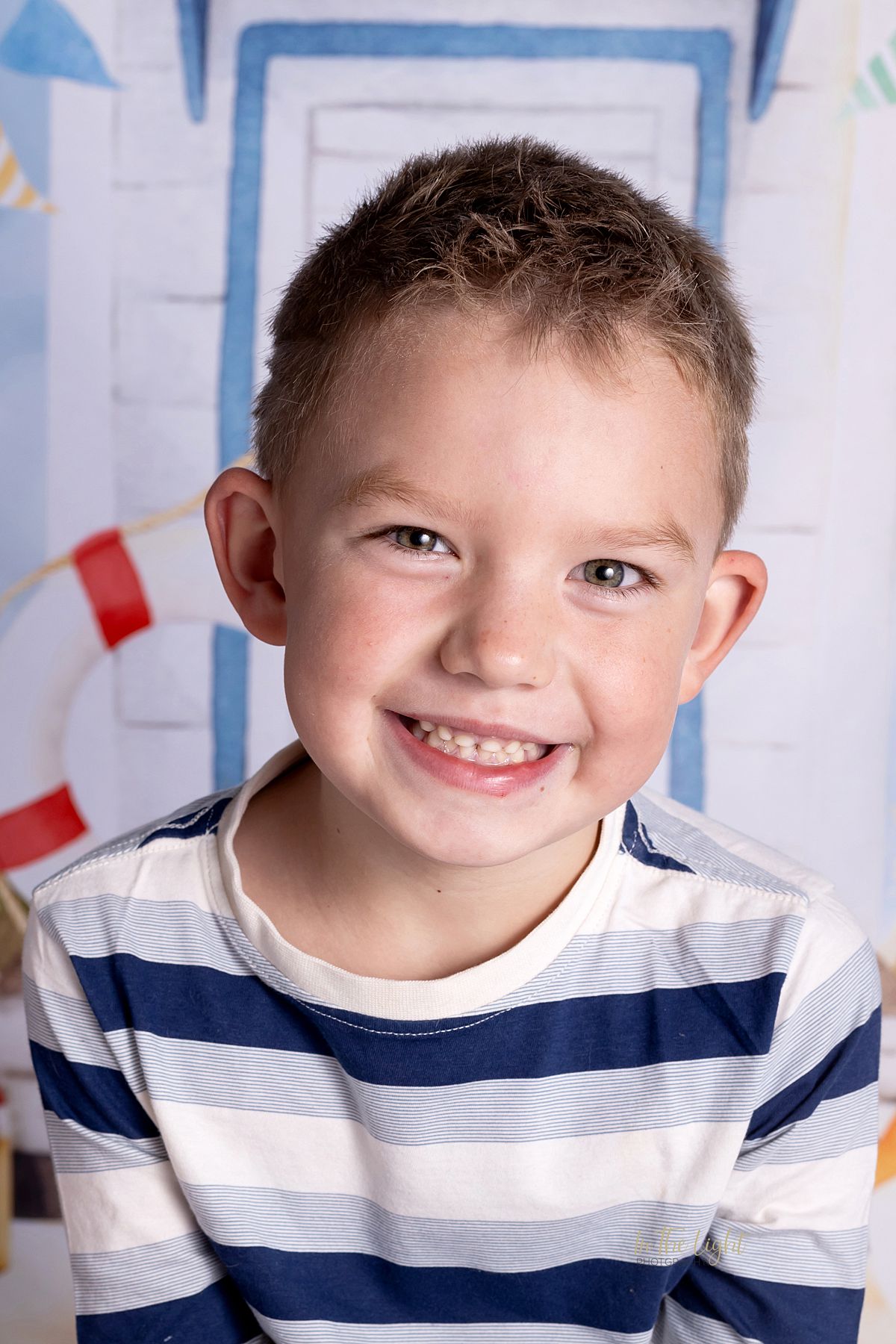 Preschool photo of a girl smiling happily during their annual nursery school photo day in Sandton