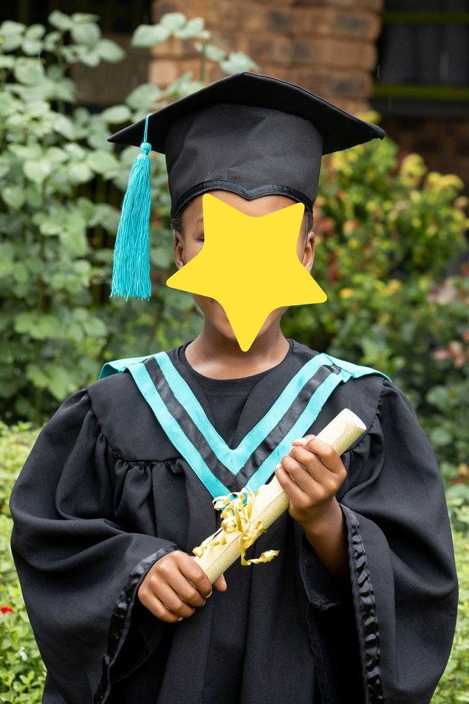 Grade R graduation photo with scroll and hat, taken outdoors in Pretoria