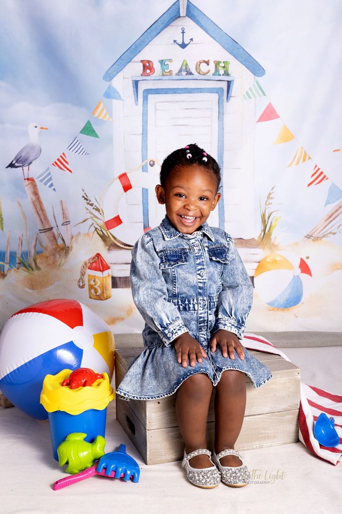 Preschool photo of a girl smiling happily during their annual nursery school photo day in Centurion
