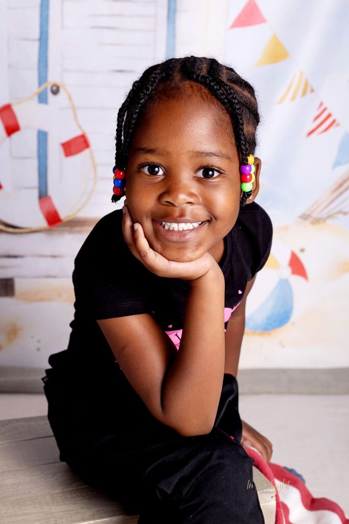 Preschool photo of a girl smiling happily during their annual nursery school photo day in Centurion