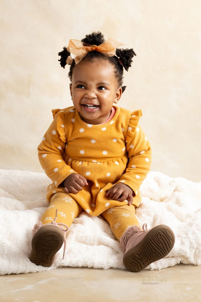 Preschool portrait photo of a baby girl laughing taken at her school in Pretoria east