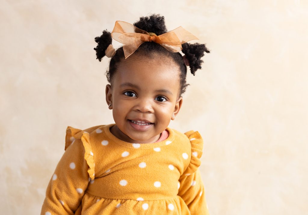 Preschool portrait photo of a baby girl smiling, studio photo in Pretoria east